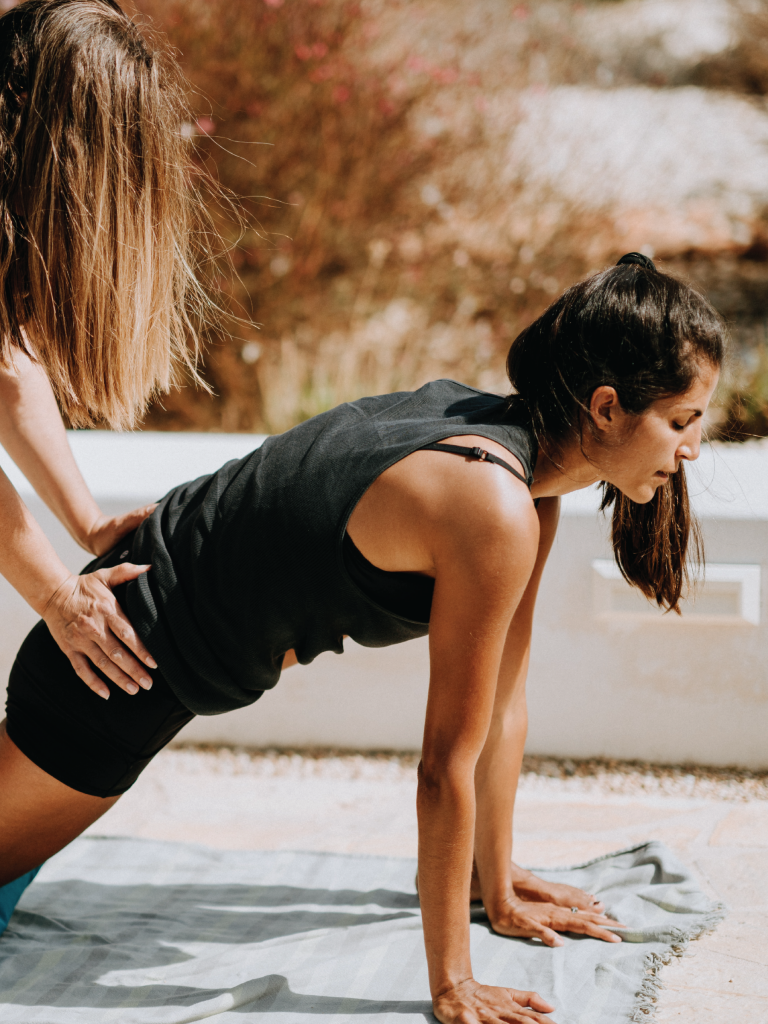 Girl assisting girl in excercise
